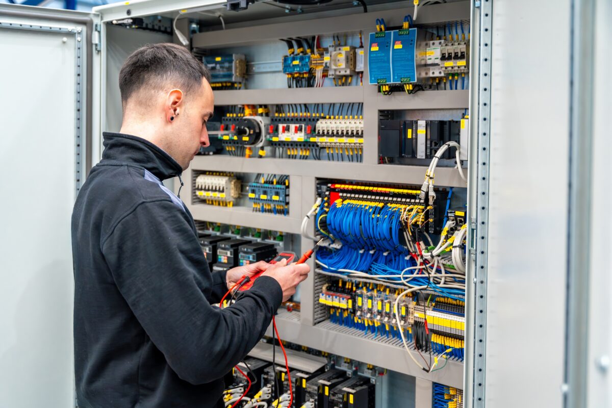 Rear,View,Of,A,Male,Worker,Repairing,An,Electrical,Mechanical