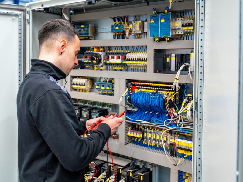 Rear,View,Of,A,Male,Worker,Repairing,An,Electrical,Mechanical
