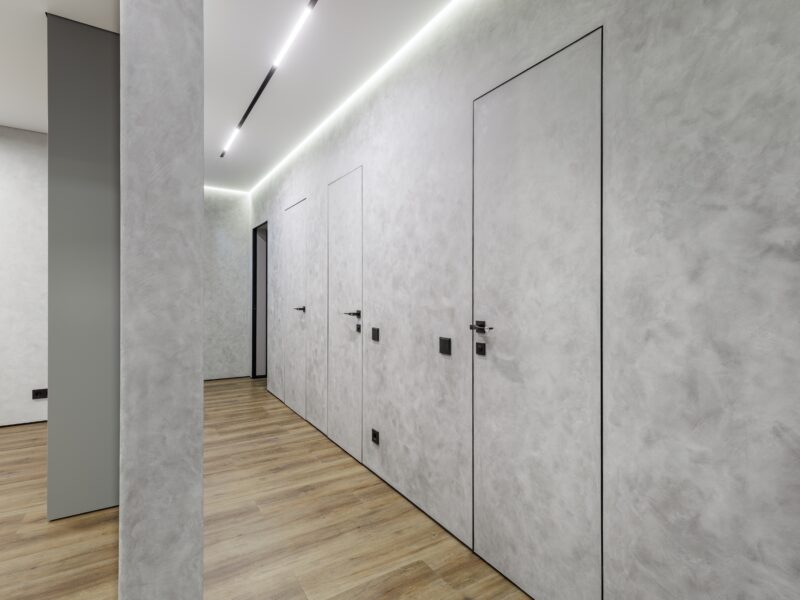 Wide angle,Perspective,Of,A,Modern,Apartment,Corridor,Featuring,Invisible,Flush